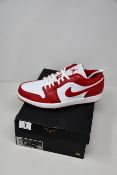 A pair of boxed as new Nike Air Jordan 1 Low Gym sneakers in red and white (UK 9).