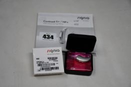 A boxed as new Signia Contrast S+ hearing aid in silver.