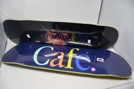 Three as new skateboard decks to include Skateboard Café 8.375 Wayne skateboard deck in green and