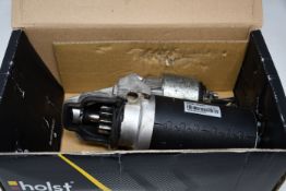 Four boxed Holst car parts and related items to include three Holst starter motors and one Holst