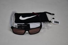 A pair of as new Nike Maverick RGE E sunglasses with protective pouch (RRP £137).