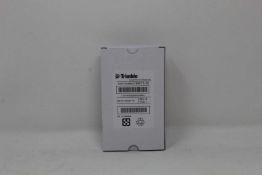 A boxed as new Trimble Rechargeable Li-Ion Battery For Robotic Total Stations (P/N: 99511-30).
