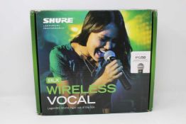A boxed as new Shure BLX24 PG58 Wireless Microphone and Transmitter (Box opened).
