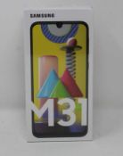 A boxed as new Samsung M31 SM-M315F/DSN 128GB in Blue (UK Plug) (Box sealed).