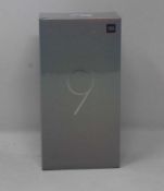 A boxed as new Xiaomi Mi 9 Global Version 6GB RAM 128GB Storage Android Smartphone in Piano Black