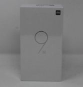 A boxed as new Xiaomi Mi 9 SE Global Version 6GB RAM 128GB Storage Android Smartphone in Piano Black