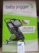 A boxed Baby Jogger City Mini 2 three wheel light weight stroller (Cosmetic damage to outer box).