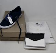 An as new Lacoste white polo shirt (US XL - RRP £95), a pair of Lacoste Leron trainers (UK 10) and a