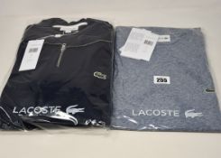 An as new Lacoste zip collar sweatshirt in blue marine (US M - RRP £100) together with a Lacost