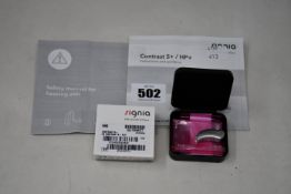 A boxed as new Signia Contrast S+ hearing aid in silver.