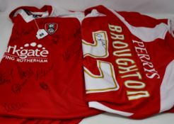 Two signed Rotherham United football shirts; a 2010-11 home shirt signed on front by over 20