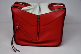 An as new Loewe small Hammock bag in red (RRP £1850).