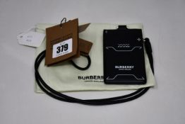 An as new Burberry leather card holder with leather strap.