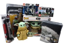 A quantity of Star Wars related items to include two Disney Legos, a large Darth Vader adult