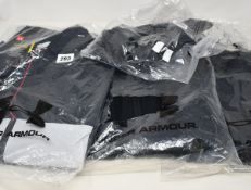 Four items of as new Under Armour sportswear; Rival fleece joggers (RRP £50), Storm waterproof