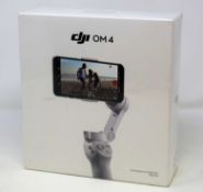 A boxed as new DJI OM 4 3-Axis Smartphone Gimbal in Grey (Box sealed).