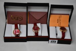 Three women's boxed Burgi Artist Pure Essence watches with leather straps.