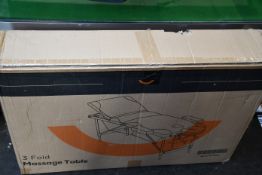 A boxed as new 3-Fold Massage Table in black and white.