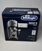 A boxed DeLonghi Dedica EC685M Coffee Machine in silver.