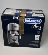 A boxed DeLonghi Dedica EC685M Coffee Machine in silver.