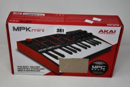 A boxed as new Akai Professional MPK Mini compact keyboard and pad controller.