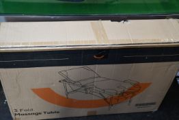 A boxed as new 3-Fold Massage Table in black and white.