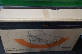 A boxed as new 3-Fold Massage Table in black and white.