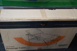 A boxed as new 3-Fold Massage Table in black and white.