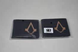 Twenty as new Assassin's Creed Syndicate Bronze Brotherhood Crest bi-fold wallets.