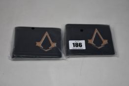 Twenty as new Assassin's Creed Syndicate Bronze Brotherhood Crest bi-fold wallets.