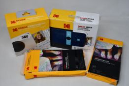 Various boxed Kodak Instant camera items to include: one Kodak Smile camera in blue, one Kodak