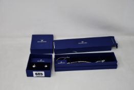 A Swarovski crystal bracelet (1808960) and a pair of Swarovski crystal earrings (Outer boxes not