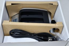 A boxed as new RRC 2-bay battery charger (PN: PMC02A) (Requires UK adapter).