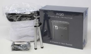 A boxed as new Piqo Smart Android Mini Projector (UK plug adaptor required) (Box sealed) with fabric