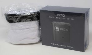 A boxed as new Piqo Smart Android Mini Projector (UK plug adaptor required) (Box sealed) with fabric