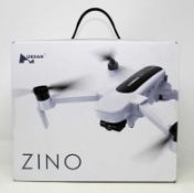 A boxed as new Hubsan Zino H117S Folding Quadcopter Drone (Box sealed. UK plug adapter required).