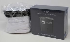 A boxed as new Piqo Smart Android Mini Projector (UK plug adaptor required) (Box sealed) with fabric
