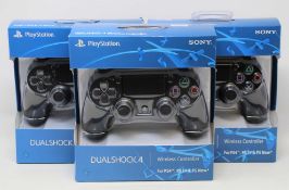 Four boxed as new Sony PlayStation DUALSHOCK 4 Wireless Controllers in Black (some damage to box).