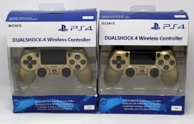 Two boxed as new Sony PlayStation DualShock 4 Wireless Controllers in Gold (Some damage to boxes).