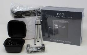 A boxed as new Piqo Smart Android Mini Projector (UK plug adaptor required) (Box sealed) with fabric
