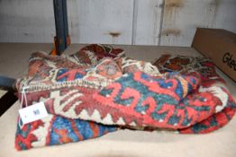 A pre-owned antique handmade woollen rug (AF).