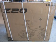 A boxed HIMO Z20 folding electric bike in white (Requires UK adaptor).