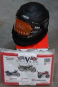 A boxed as new Yema matt black motorcycle helmet in large together with a motorcycle vac bag.