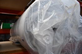 A rolled mattress (Size unknown).