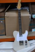 An as new Vintage V62 ReIssued electric guitar in ash blonde.