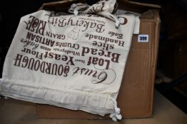 A quantity of drawstring bags with bread motifs to front.