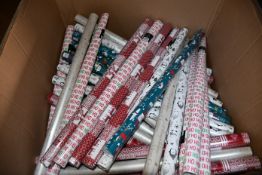A quantity of as new Christmas wrapping paper in various designs (Approximately 40 rolls).