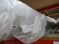 A rolled mattress (Size unknown).