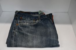 A pair of as new (Di)vision upcycled knee zip denim jeans (W31/L34).