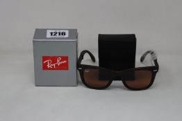 A pair of as new Ray Ban Wayfarer folding sunglasses.
